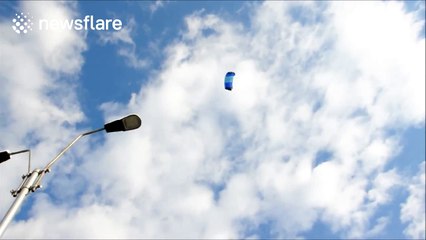 Skydiving Father Christmas gets stuck on lamp post
