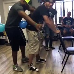 Guys Playing the 'Balloon Hump' Party Game