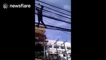 Man walks on electric cables in Thailand