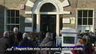 Pregnant Kate visits charity amid author row