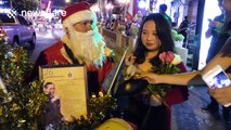 Man dressed as Santa Claus gives New Year wishes in Thailand