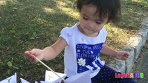 Toddler learning ABC Alphabets on a White Flags _ Fun outdoors park-nQaIsXvJ