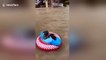 British tourists float down Thai flooded street on lilos