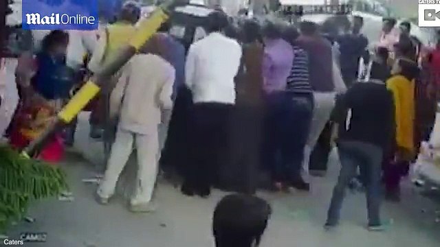 Indian woman sandwiched between two cars is caught on camera