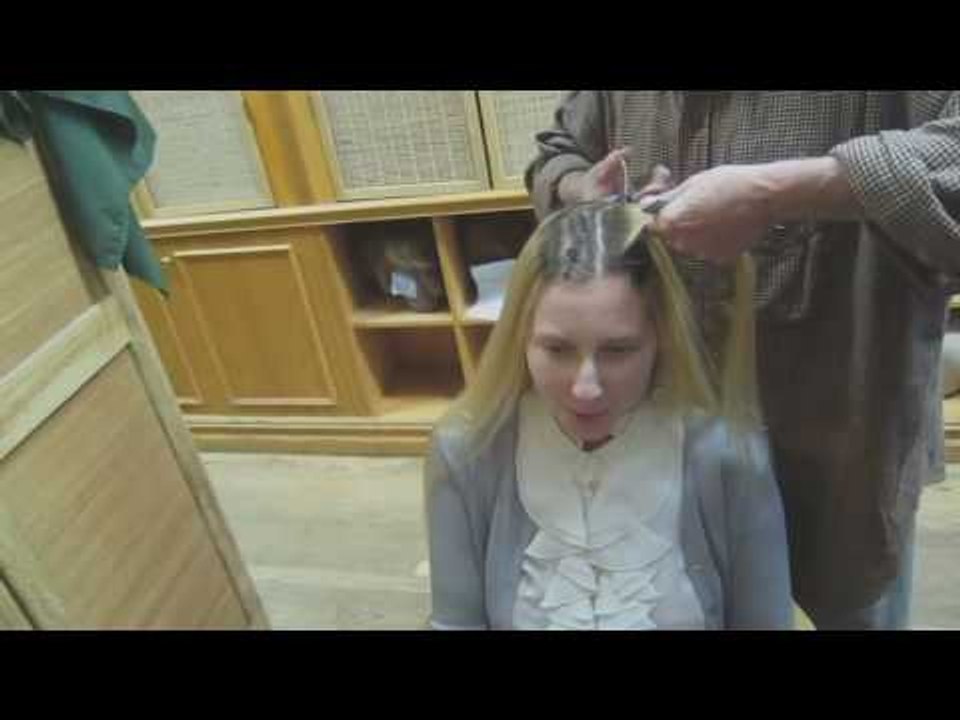 Blonde woman cuts her long blonde hair to a short pixie cut