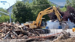 Komatsu Excavator breaking up a foundation from a building demolition