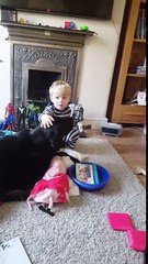 Little boy preciously sings his dog a lullaby