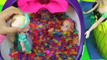 Elsa and Anna toddlers have fun in ORBEEZ ! They slide into colorful water jelly balls!