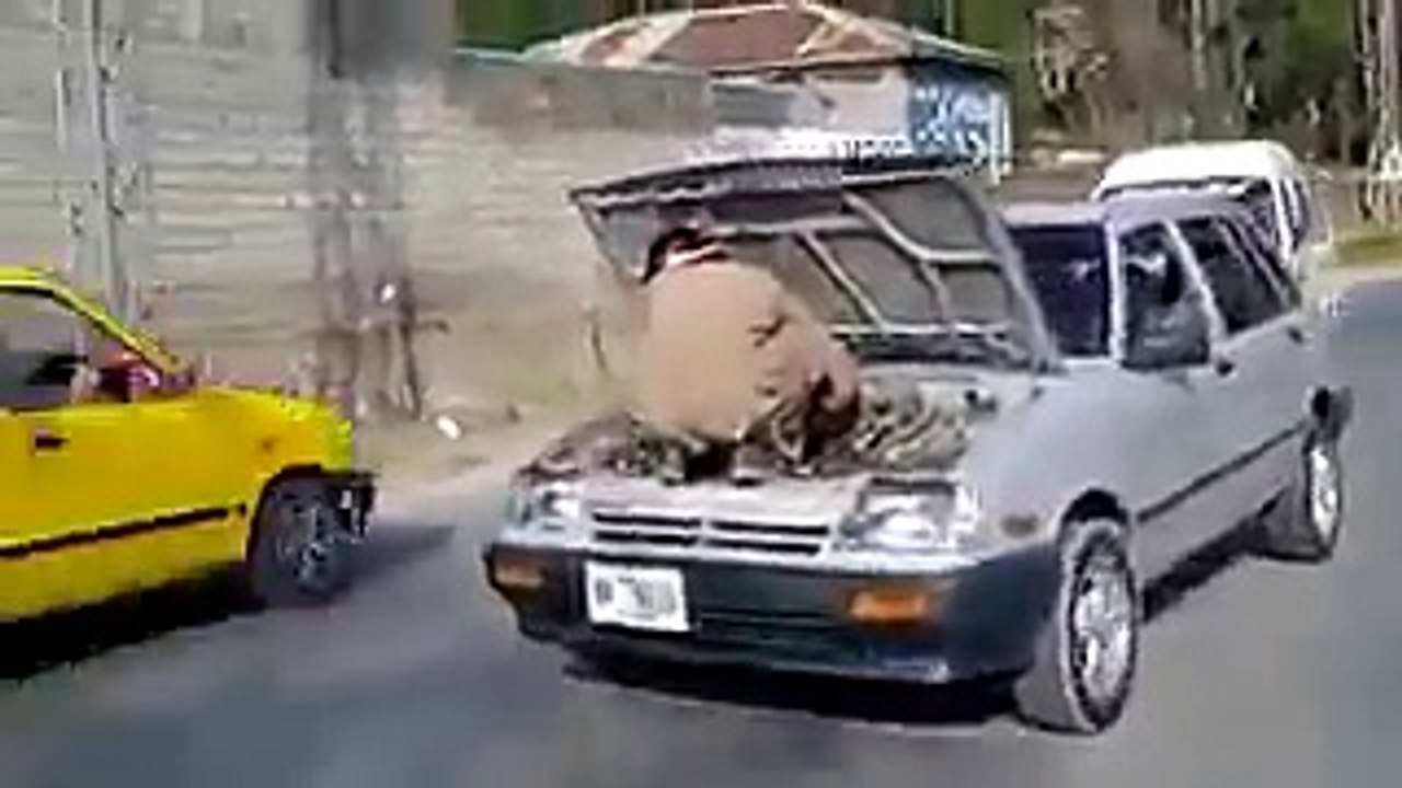 A mechanic fixing a moving car in pakistan