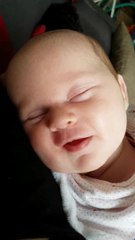 Baby preciously giggles in her sleep