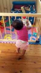 Baby dances along to toy robot