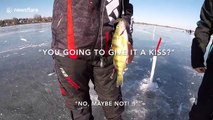 Fishermen catch perches in ice-fishing holes