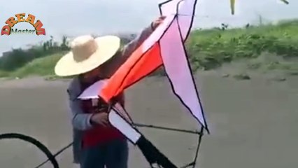 Beautiful kite flying in the sky just like a man riding cycle.