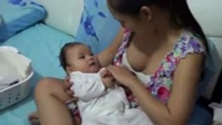 Beautiful woman giving breast feeding to her baby