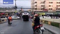 Driver's overloaded truck tips over backwards on a bridge