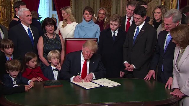 President Trump signs executive orders after taking office