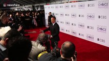 Tom Hanks jokes with photographers on the red carpet of The 2017 Peoples' Choice Awards