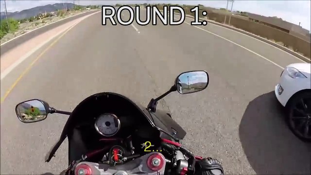 Motorbikes are quick, but watch this Tesla stomp all over this bike