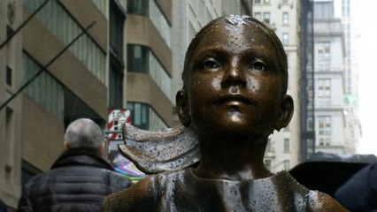 Statue of young girl stares down Wall Street bull