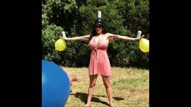 Hot Womam holding Balloons and Soda Cans while a Man Bursting it with a Gun