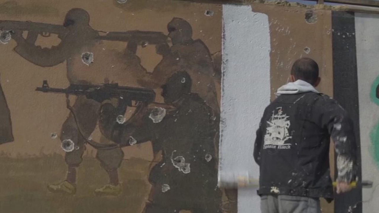 Iraqis erase traces of ISIL in east Mosul with a coat of paint