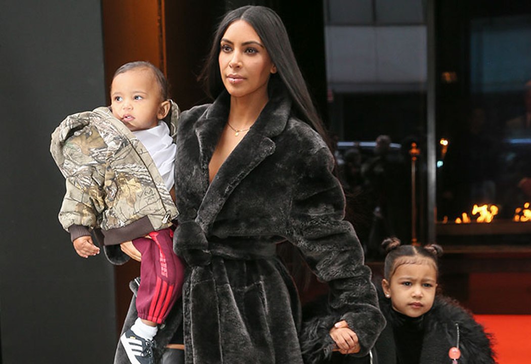 Kim Kardashian & North West Match In Dark Fur Coats Out In NYC