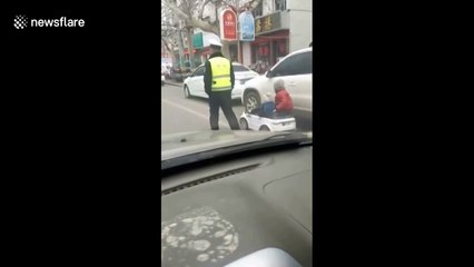 Four-year-old girl and her younger brother drive toy car on road