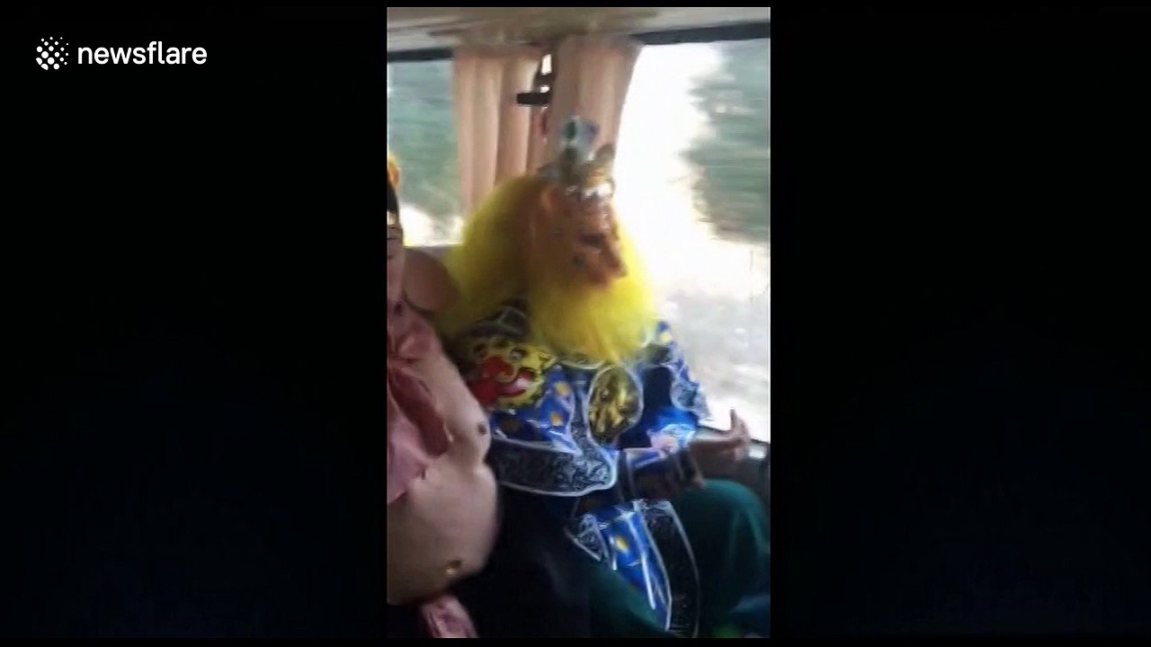 Man dressed as Monkey King drives bus full of mythological characters