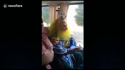 Man dressed as Monkey King drives bus full of mythological characters