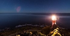 Swirling Galaxy Over Lighthouse Captured in Gorgeous Timelapse