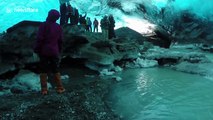 Tourists explore ice cave under glacier in Iceland