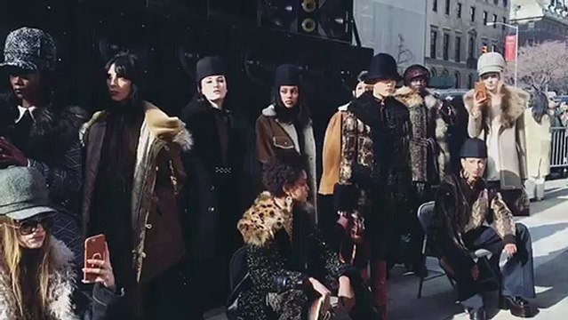 All the models of the #MarcJacobs show are meeting the guests outside the venue for a group shot, with big speakers behind them playing loud music.