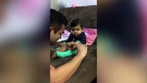 Cute baby pretends to cry when her dad goes to cut her nails