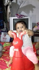 Nice looking funny girl baby playing with toy...
