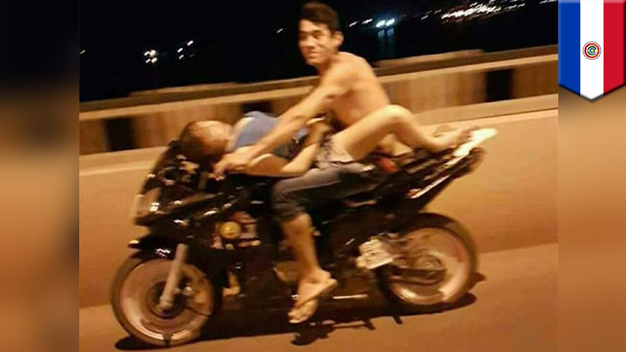 Couple filmed riding each other while riding a motorcycle