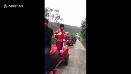 Groom uses nine oxcarts and two tractors to pick up bride
