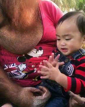 Orangutan cuddles with baby boy