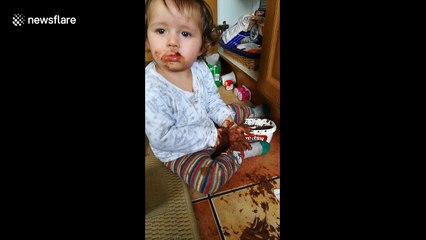 Cheeky baby spreads chocolate all over parents' kitchen