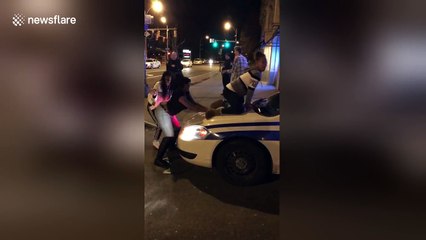 Girl twerks on police car in New York