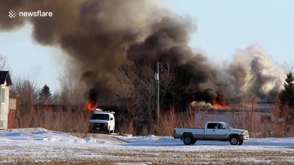 Firefighters battle raging house fire