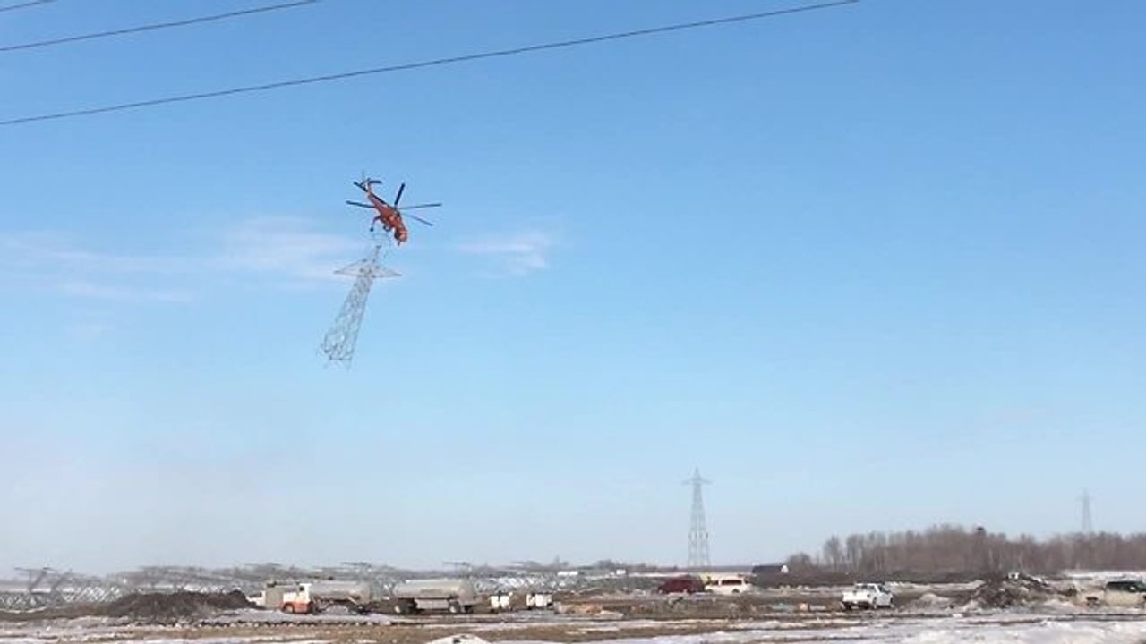 Helicopter picks up transmission tower with ease