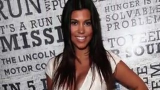 Pregnant Kourtney Kardashian Wears a White Lace Onesie on the Red Carpet