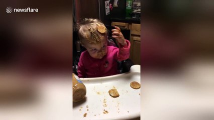 Baby smears peanut butter all over herself