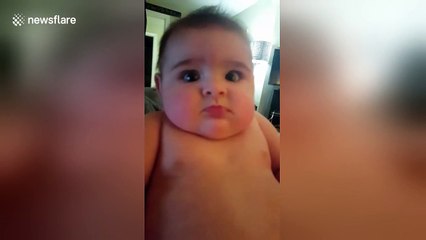Baby pulls sad face when her mother sings to her