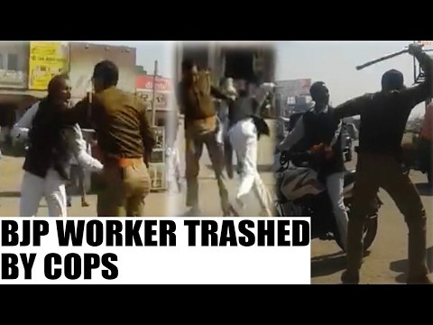 BJP worker thrashed by UP Police for carrying party flag, Watch Video | Oneindia News