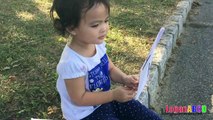 Toddler learning ABC Alphabets on a White Flags _ Fun outdoors park-nQaIsX