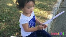 Toddler learning ABC Alphabets on a White Flags _ Fun outdoors park-nQaIsXv