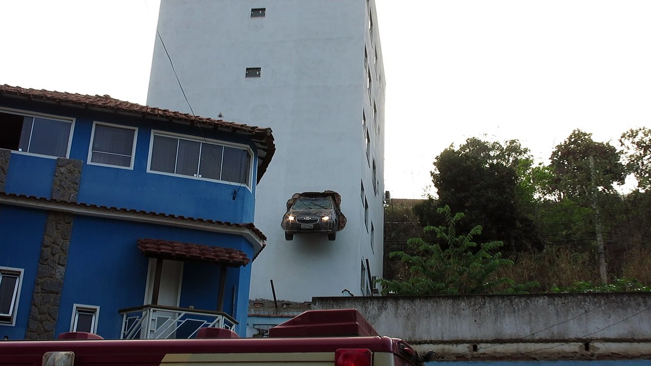 Car Drives Through Building Wall