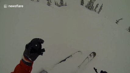 Avalanche knocks skier off cliff