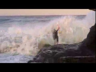 Surfer Collides With Rocks After Getting Struck by a Huge Wave